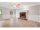 Living room with brick fireplace and hardwood floors at 1486 Willow Bnd, Woodstock, GA 30188