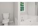 Clean bathroom with toilet and bathtub at 1486 Willow Bnd, Woodstock, GA 30188
