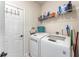 Laundry room with washer, dryer, and ample storage shelving at 426 Samara Ct, Fairburn, GA 30213