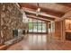 Living room with stone fireplace and wood paneled walls and ceilings at 5005 Jones Rd, Fairburn, GA 30213