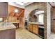 Kitchen with double ovens, wood cabinets, and tile flooring at 5005 Jones Rd, Fairburn, GA 30213