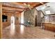 Living room with stone fireplace, wood paneling, and hardwood floors at 5005 Jones Rd, Fairburn, GA 30213