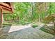 Spacious flagstone patio surrounded by lush landscaping and mature trees at 5005 Jones Rd, Fairburn, GA 30213