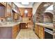 Long view of the kitchen with wood cabinets and tile flooring at 5005 Jones Rd, Fairburn, GA 30213