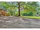 Large backyard with mature trees and a view of the street at 5005 Jones Rd, Fairburn, GA 30213