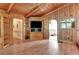 Living room with built-in entertainment center and wood paneling at 5005 Jones Rd, Fairburn, GA 30213