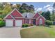 Brick ranch home with 2-car garage and landscaped lawn at 2677 Gold Rust Dr, Buford, GA 30519