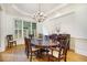 Bright dining room featuring hardwood floors, a large table, and window shutters at 2262 Meadowvale Ne Dr, Atlanta, GA 30345