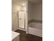 Bathroom with shower and garden tub, dark floors at 7298 Rockhouse Rd # 5, Austell, GA 30168