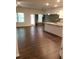 Open concept kitchen with island and dark hardwood floors at 7298 Rockhouse Rd # 5, Austell, GA 30168