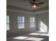 Spacious bedroom with three windows and ceiling fan at 7298 Rockhouse Rd # 5, Austell, GA 30168