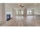 Spacious living room with hardwood floors, fireplace, and access to the kitchen at 234 Linford Dr, Locust Grove, GA 30248