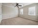 Bright bedroom with neutral walls, carpet flooring, and two large windows at 4842 Coach Ln, Dunwoody, GA 30338