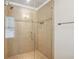 Large walk-in shower with neutral tile and glass enclosure at 4842 Coach Ln, Dunwoody, GA 30338