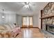 Living room featuring hardwood floors, stone fireplace, and ceiling fan at 1922 Marshes Glenn Dr, Norcross, GA 30071