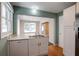 Eat-in kitchen with white cabinets and a double sink at 690 Green Acres Se Rd, Smyrna, GA 30080