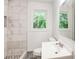 Updated bathroom with a large walk-in shower and marble tile at 690 Green Acres Se Rd, Smyrna, GA 30080