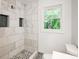 Modern bathroom with marble tile shower and updated fixtures at 690 Green Acres Se Rd, Smyrna, GA 30080