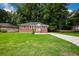 Brick Ranch home with a large front yard, driveway, and landscaping at 690 Green Acres Se Rd, Smyrna, GA 30080