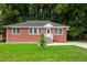 Brick Ranch home with a large front yard, driveway, and landscaping at 690 Green Acres Se Rd, Smyrna, GA 30080