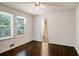 Bedroom with hardwood floors, ceiling fan, and access to bathroom at 690 Green Acres Se Rd, Smyrna, GA 30080