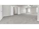 Spacious main bedroom with grey carpet and multiple doors at 2146 Silva Ct, Conley, GA 30288