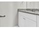 Bathroom vanity with granite countertop and white cabinets at 2146 Silva Ct, Conley, GA 30288