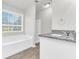 Bathroom with granite countertop, white cabinets, and a bathtub at 2146 Silva Ct, Conley, GA 30288