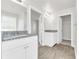 Bathroom with granite countertop, white cabinets, and wood-look floor at 2146 Silva Ct, Conley, GA 30288