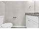 Small bathroom with granite countertop and white cabinets at 2146 Silva Ct, Conley, GA 30288