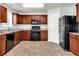 Updated kitchen, featuring wood cabinets and black appliances at 2146 Silva Ct, Conley, GA 30288