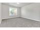 Spacious bedroom with grey carpet, large window, and neutral walls at 2146 Silva Ct, Conley, GA 30288