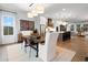 Open concept dining room with modern farmhouse style table and chairs, adjacent to the kitchen at 130 Chiswick Cir, Alpharetta, GA 30009