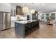 Open concept kitchen boasts stainless steel appliances and an island with seating at 130 Chiswick Cir, Alpharetta, GA 30009