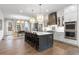 Open kitchen boasts a large island, stainless steel appliances, and custom cabinetry at 130 Chiswick Cir, Alpharetta, GA 30009