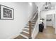 Modern staircase with dark wood railings and a black console table at 130 Chiswick Cir, Alpharetta, GA 30009