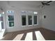 Bright bedroom with hardwood floors, multiple windows, and a ceiling fan at 214 Strawberry Ln, Woodstock, GA 30189