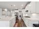 Modern kitchen with island, white cabinets, and stainless steel appliances at 1283 Maston Rd, Auburn, GA 30011