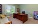 Home office with built-in shelving and hardwood floors at 981 Cranbrook Glen Ln, Snellville, GA 30078