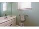 Simple bathroom with vanity, toilet, and a mirror at 981 Cranbrook Glen Ln, Snellville, GA 30078