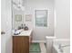 Clean bathroom with wood vanity, bathtub, and window at 6280 Wiscasset Nw Pkwy, Dallas, GA 30157