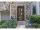 Inviting front entrance with stone facade and a charming glass door at 6280 Wiscasset Nw Pkwy, Dallas, GA 30157