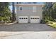 Two-car garage with white doors and ample driveway space at 6280 Wiscasset Nw Pkwy, Dallas, GA 30157