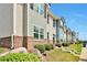 Townhouses with gray and blue siding, brick accents, and landscaping at 4433 Pinscher St, Union City, GA 30291