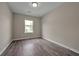 Spacious bedroom with wood-look flooring and a large window at 4433 Pinscher St, Union City, GA 30291