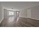 Open living room with gray vinyl plank flooring and natural light at 4433 Pinscher St, Union City, GA 30291
