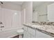 Bathroom featuring granite countertop, single vanity, and a tub shower combo at 4433 Pinscher St, Union City, GA 30291