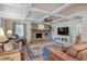 Open living room with a stone fireplace, hardwood floors, and a ceiling fan at 294 Puckett Se Rd, Emerson, GA 30137