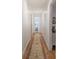 Light-filled hallway featuring hardwood floors and a decorative area rug at 294 Puckett Se Rd, Emerson, GA 30137