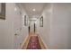 Long hallway with hardwood floors and a patterned runner, offering access to multiple rooms at 294 Puckett Se Rd, Emerson, GA 30137